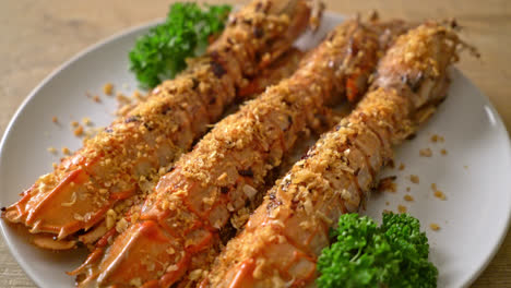 grilled tiger prawns or shrimps with lemon on wood board