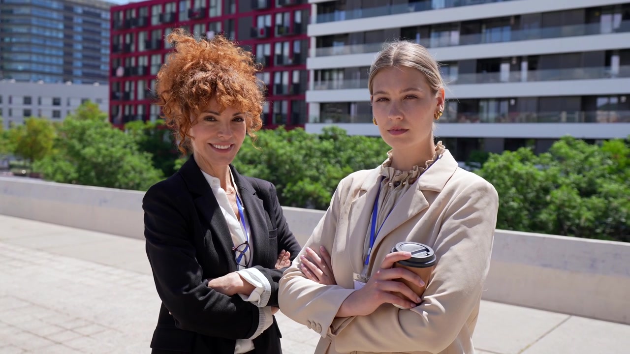 Two Professional Businesswomen Standing Outdoors in an Urban Setting