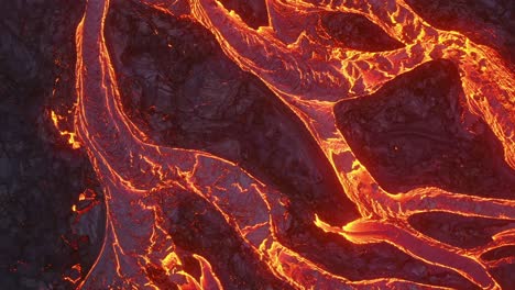 a 4k drone captures cinematic, one-of-a-kind close-up shots of cascading lava, resembling abstract tree roots, from an aerial perspective