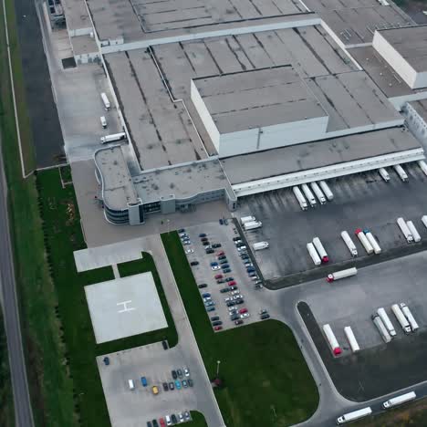 large industrial zone. modern plant with car parking on field. view from the air on industrial complex with trucks nearby. aerial view.
