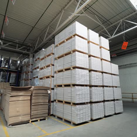 packed pallets of a parquet board stand in the warehouse at a woodworking plant. warehouse stocks for floorboard sales