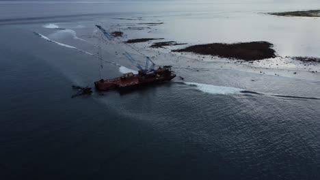 abandoned shipwreck polluting coral reef aerial shot