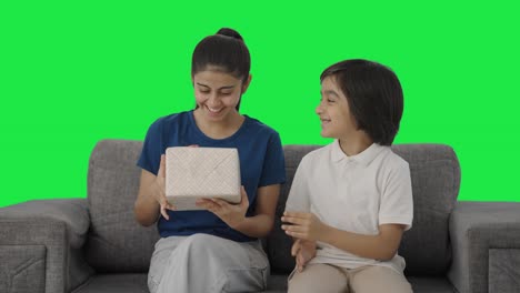 Indian-boy-giving-gift-to-his-sister-Green-screen