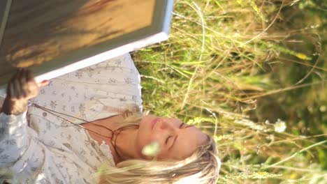 creative beautiful female artist paints a picture with acrylic paints outdoors in the forest