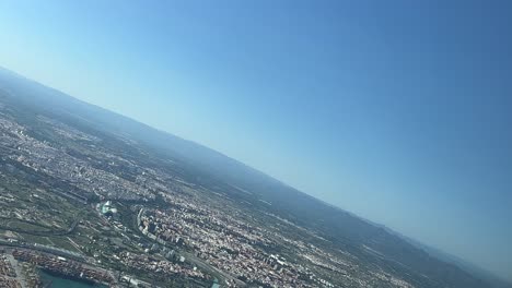 panoramic view of valencia city, spain, during the final left turn to the airport’s runway 30 to land