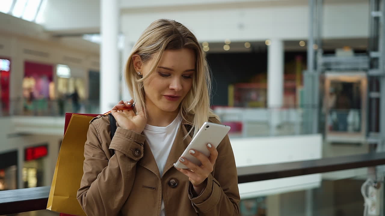 Woman shopping in a mall using her phone