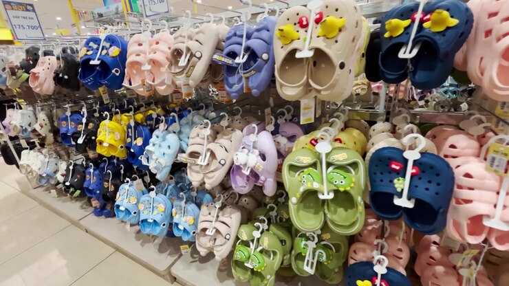 Colorful Children's Clogs Displayed on Shelves in a Retail Store
