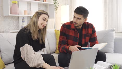 Young-man-comforting-his-girlfriend-and-trying-to-make-her-happy.