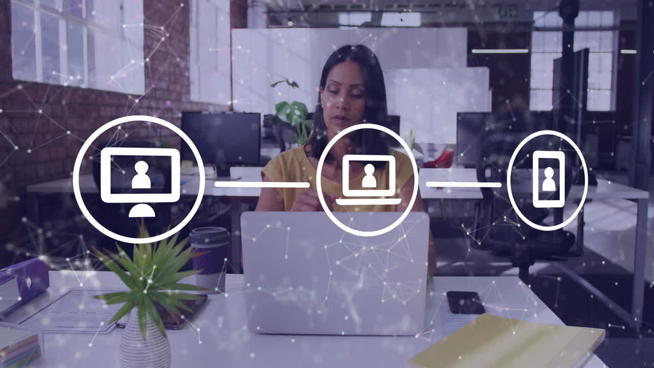 animación de una red de iconos digitales contra una mujer biracial pensativa que usa una computadora portátil en la oficina