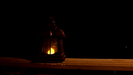 retro style lantern at night. beautiful colorful illuminated lamp at the balcony in the garden. selective focus