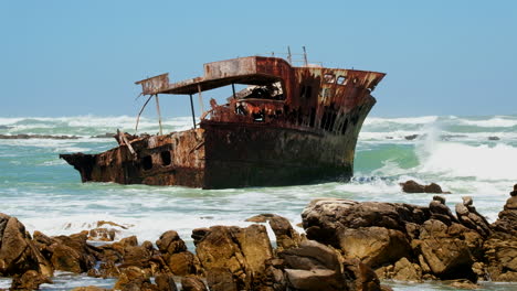 rusted old shipwreck of meisho maru no 38 stuck on rocky coastline, agulhas