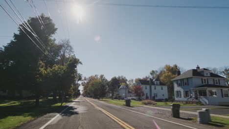 Conduzca-Por-Una-Calle-Típica-De-Un-Pueblo-Americano-En-Un-Claro-Día-De-Otoño.-Vista-De-La-Ventana-Trasera