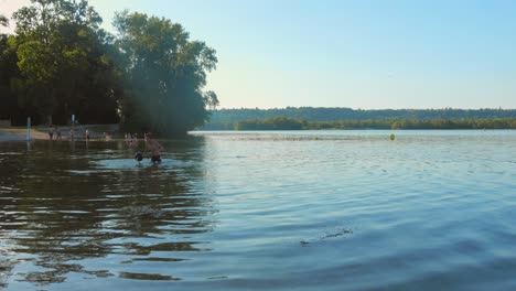 sot of famous "grand parc de miribel-jonage" lake in lyon, france during summer morning. tourists enjoying in lake. 4k.