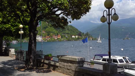 scenic view of lake como, italy with boats and mountains