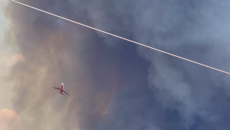 water transporter jet flies directly above with massive dark smoke in background