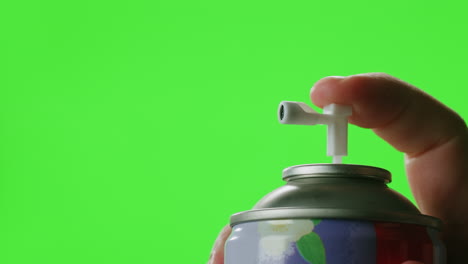 hand using air freshener spray
