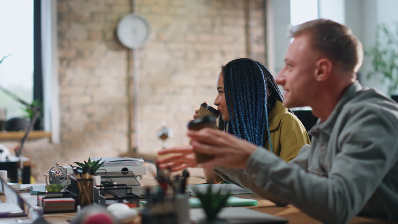 Office team drinking coffee sitting coworking space closeup. Staff sharing ideas