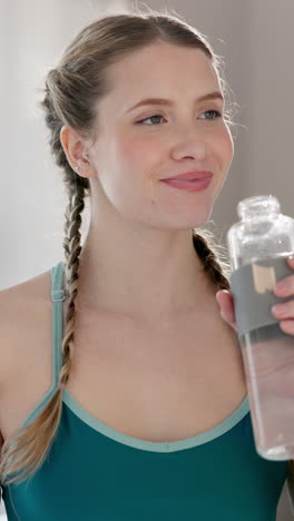 woman drinks water after a workout