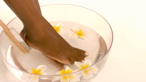 woman using brush on her foot