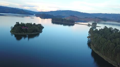 mirror reflections on tranquil water of lake bunyonyi, uganda, africa