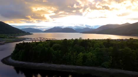 4k aerial drone footage above water and mountains at sunset in scottish highlands scotland uk