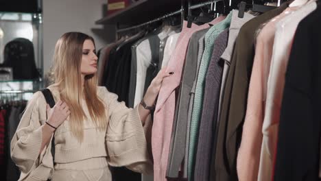 woman shopping for sweaters in a clothing store