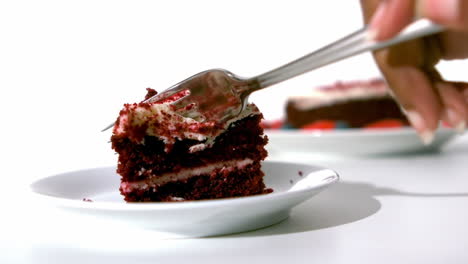 woman taking a piece of cake