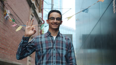 young man smiling in city alley