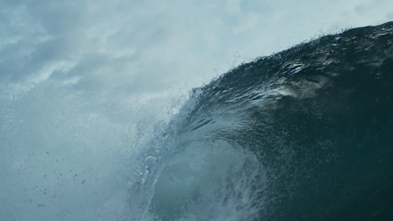 Ocean wave curling over with dramatic light and spray, slow motion, empty nobody
