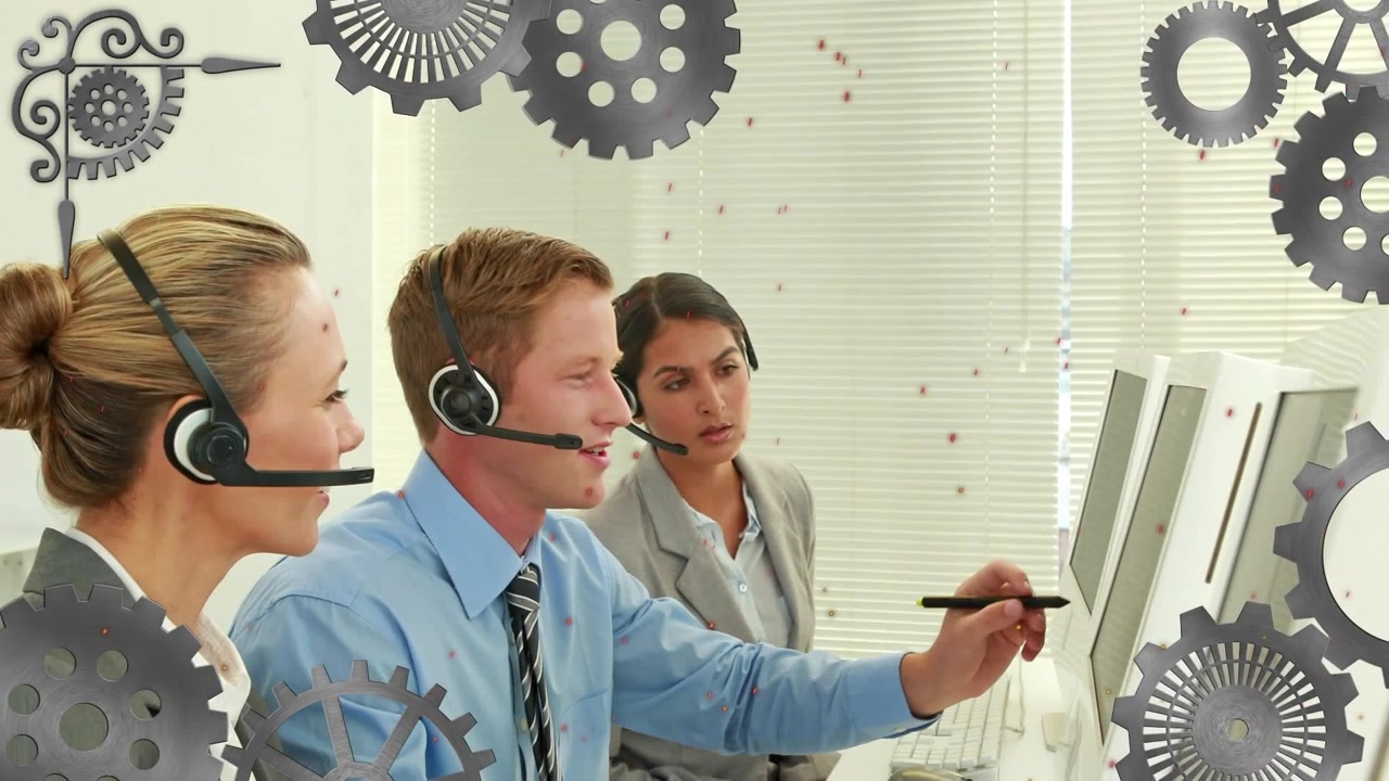 Animation of mechanical gears over diverse male agent explaining over computer to female colleagues