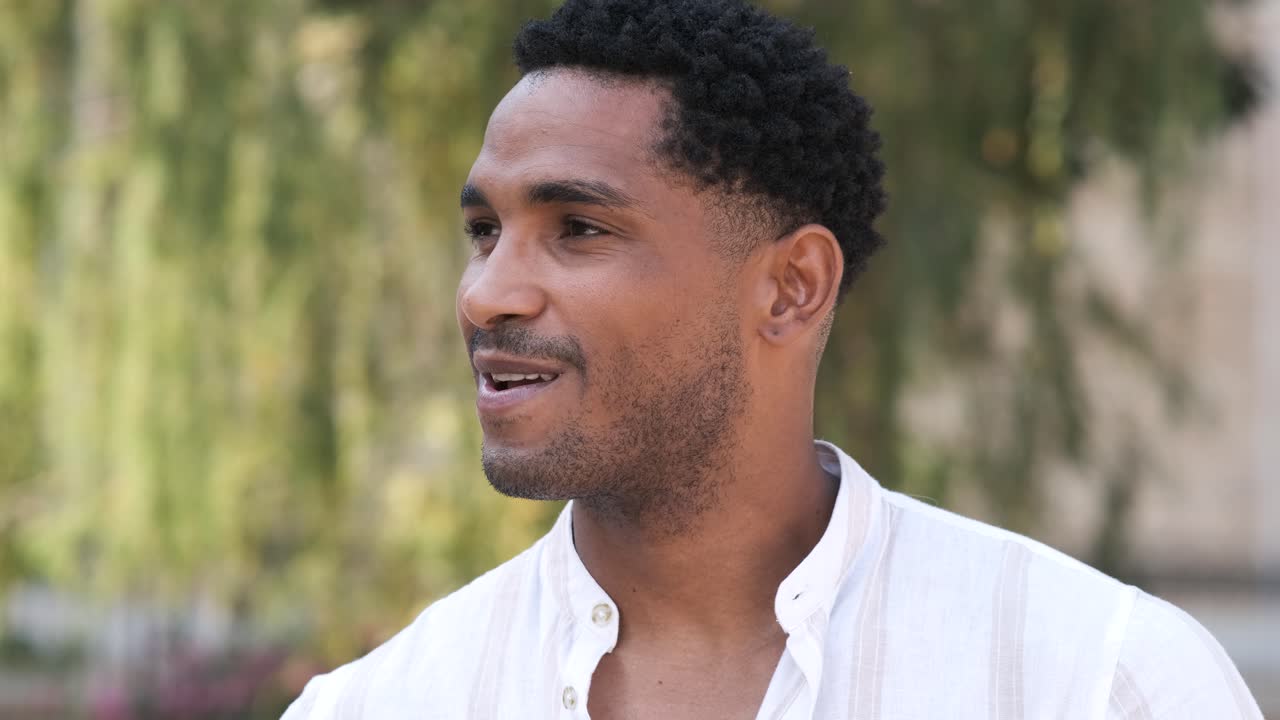 Closeup of happy young man looking at camera during daytime