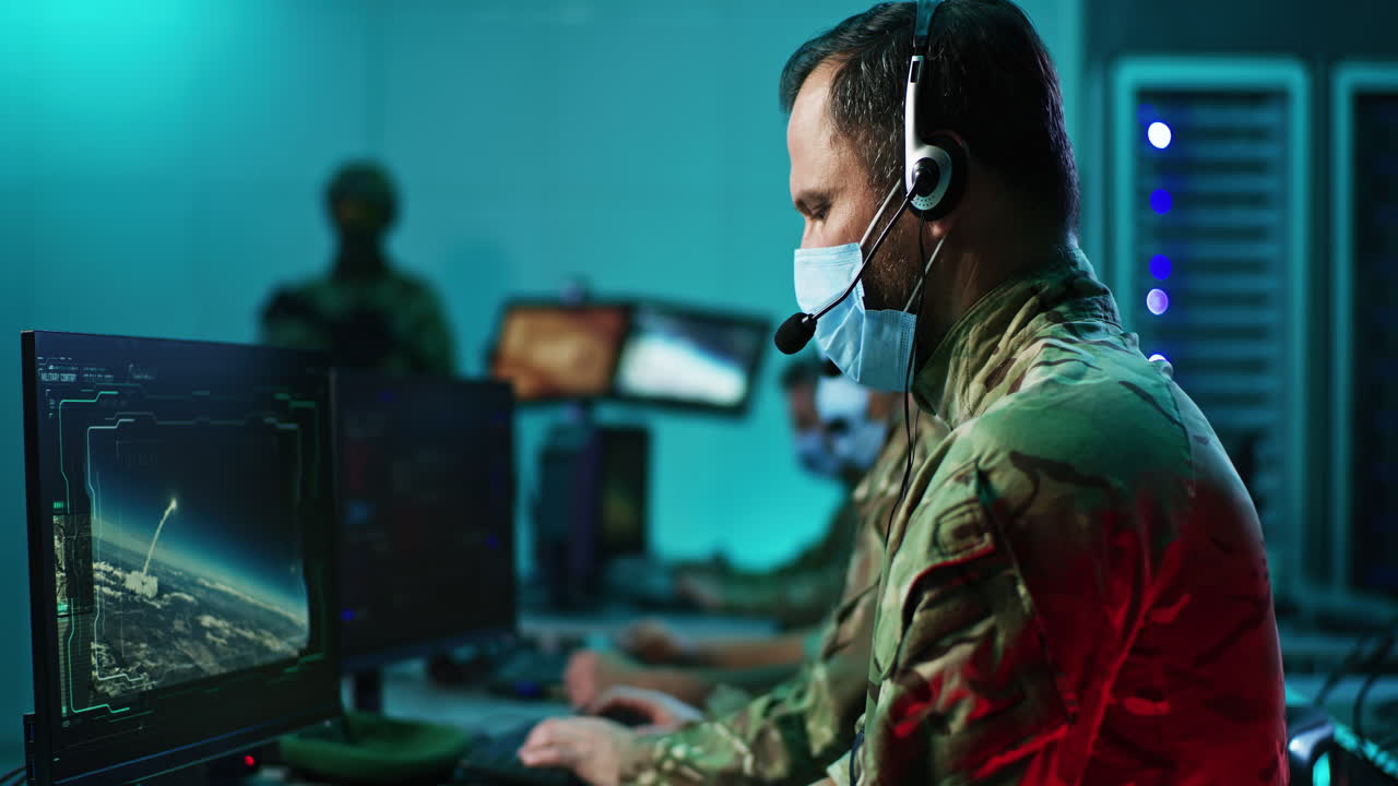 Military personnel in a mission control center monitoring a space launch
