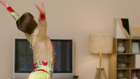 cheerful young girl dancing at home with colorful outfit