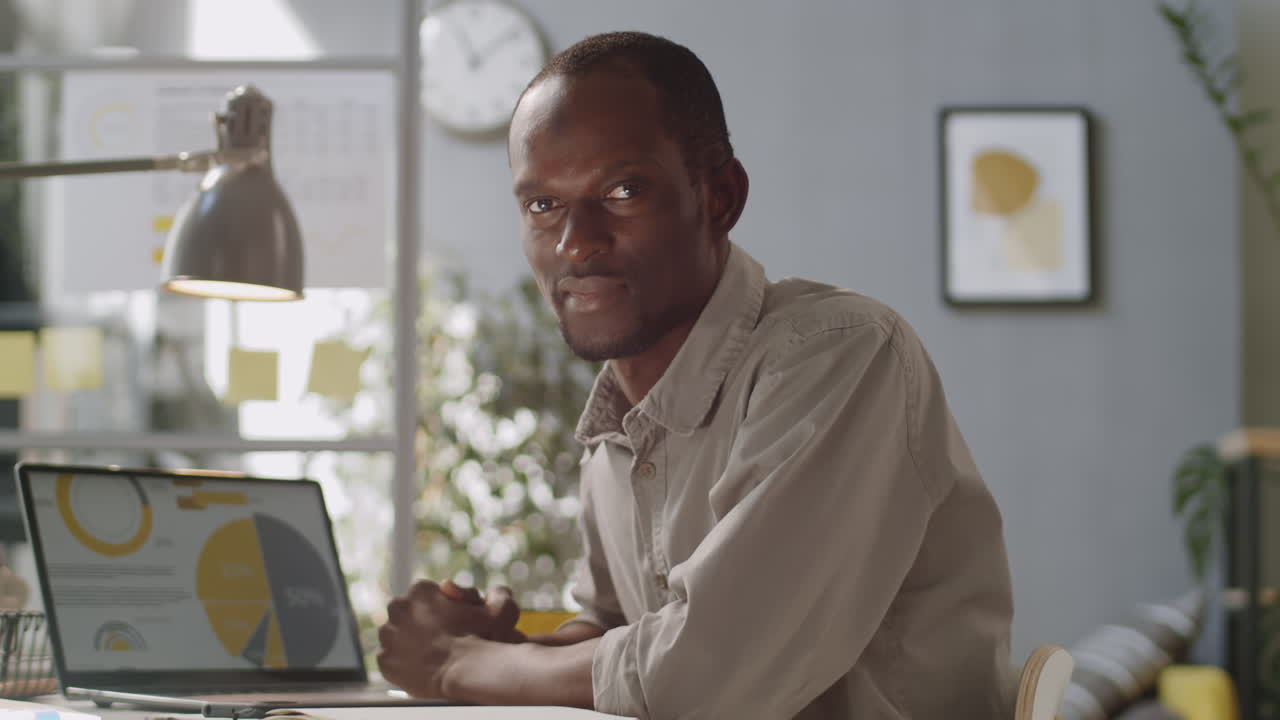 Cheerful African American Man Posing at Office Workplace