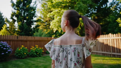 a young girl with a ponytail walks through a sunny backyard garden