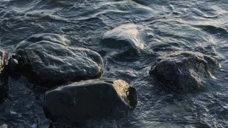 waves crashing at the rocks on the beach at daylight