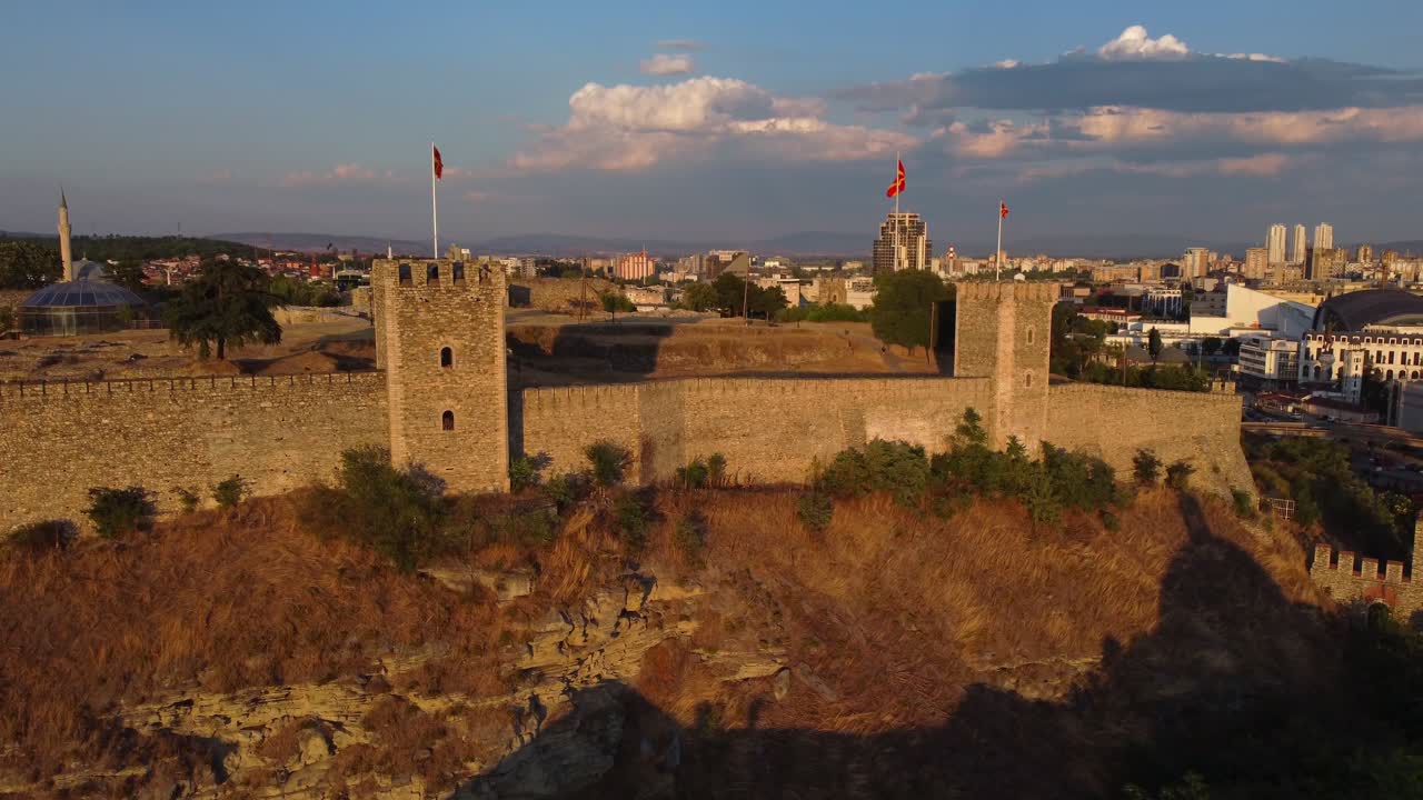 Drone view of Skopje Fortress with Macedonia Flags and Skopje City in background - North Macedonia