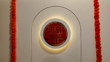 beautiful 4k stock footage of 'shaadi wala ghar' wedding decoration entrance with glowing text, floral garlands and elegant backdrop. indian marriage themes, event setups, festive celebrations.