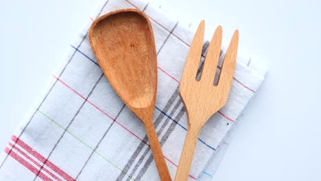 wooden spoon and fork on checkered cloth