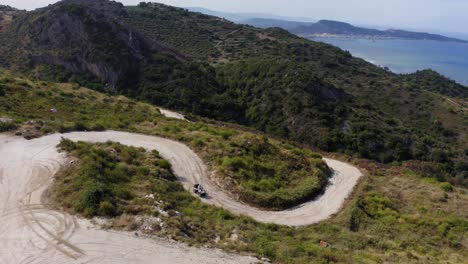 atv off-roading in mountains with ocean view