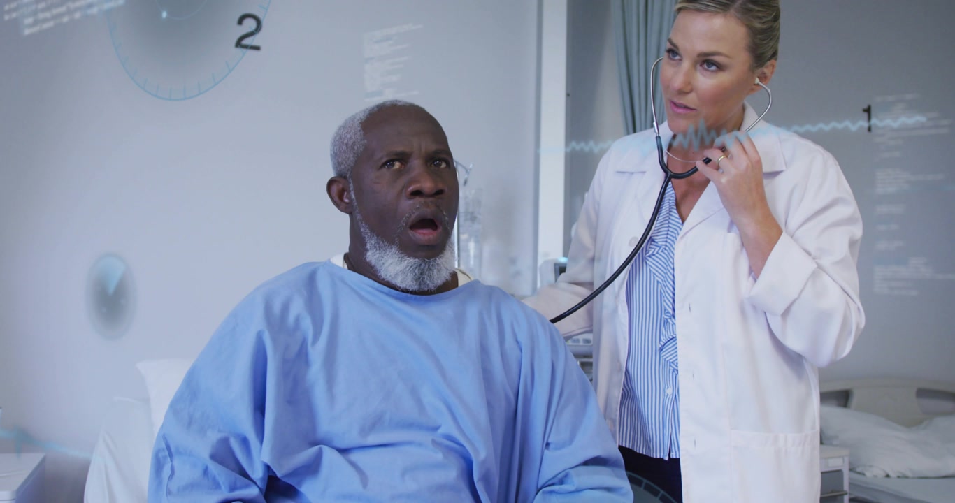 Female doctor entering ward placing scope on patient chest with live ECG graph monitoring heartbeat