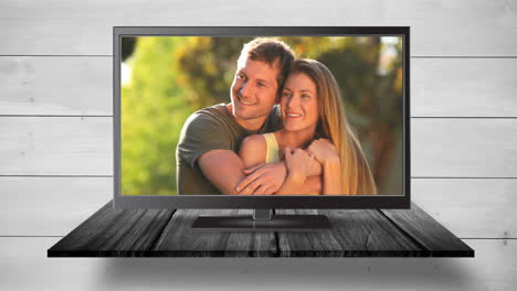 television with happy couple on its screen