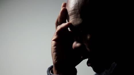 man-praying-to-god-with-hands-together-on-grey-background-stock-footage