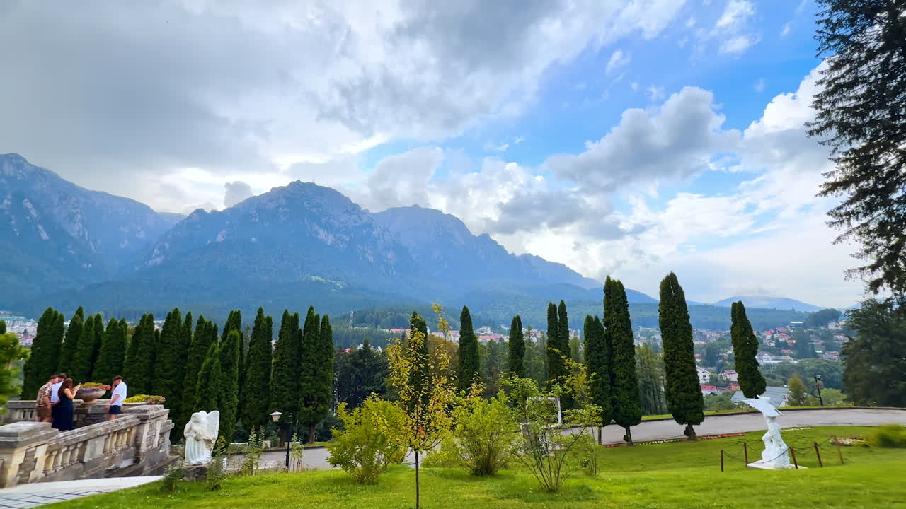 Busteni, Romania, 17 July 2025: View on the territory of Cantacuzino Castle in Busteni, Romania. Beautiful nature and stunning mountains under cloudy sky