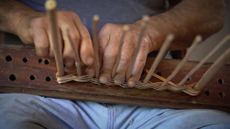 old man building wicker basket