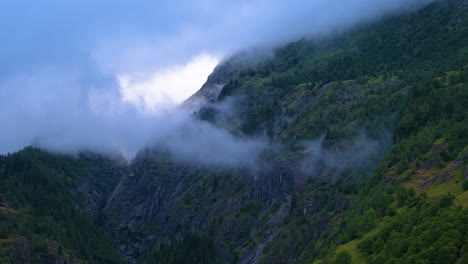 cinematic aerial shot of a misty canyon in switzerland