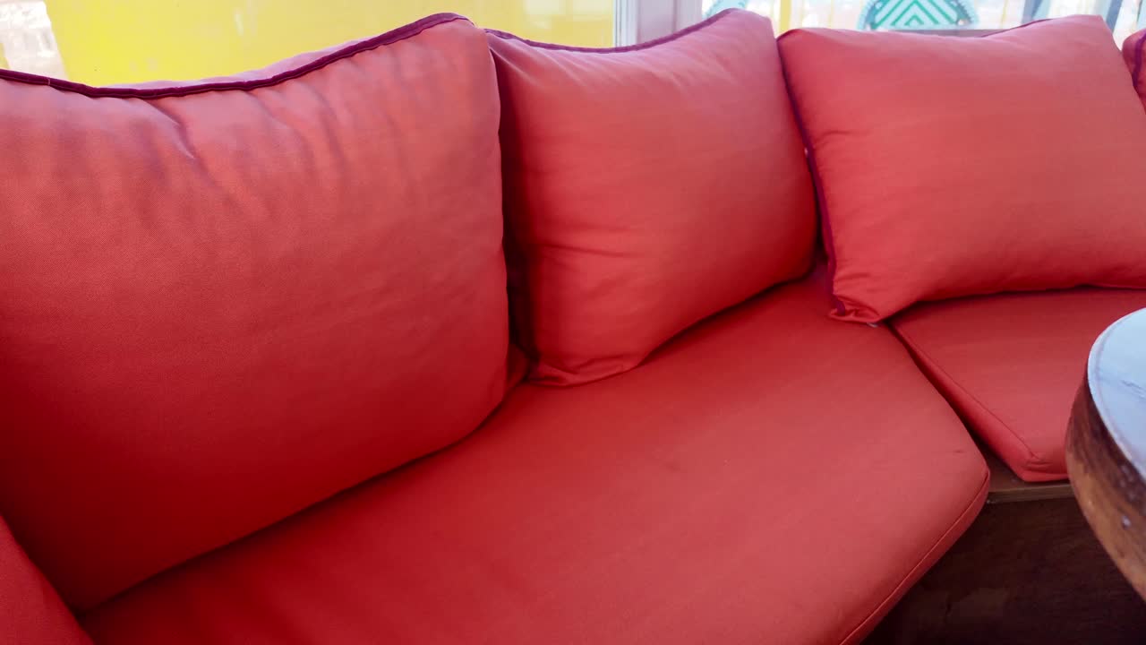 Close-up of coral cushions and pillows on a couch