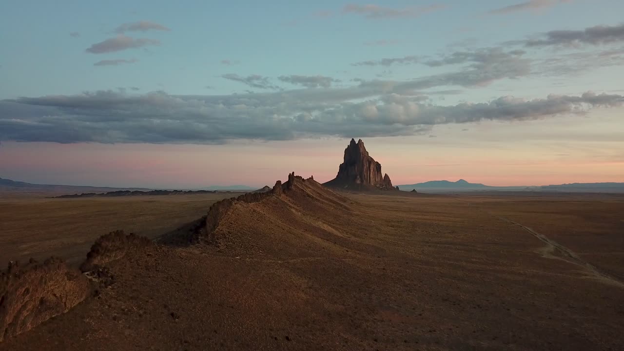 Drone flight ascending revealing massive rock formation in New Mexico