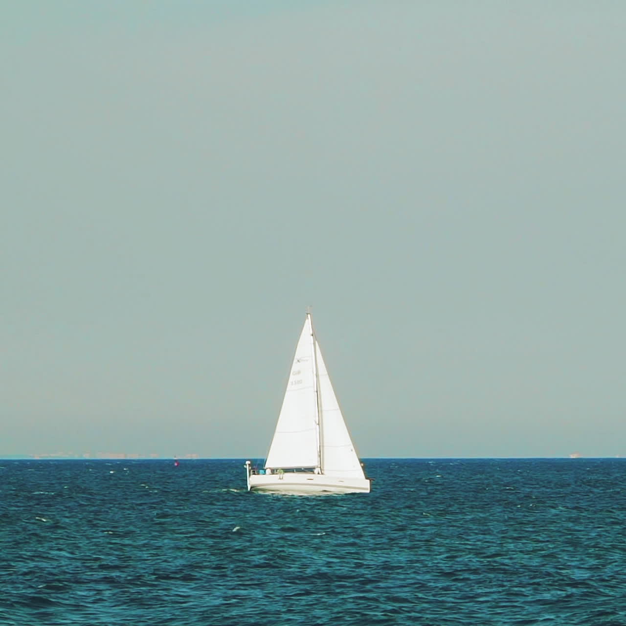 Sea with a sailboat on the horizon. Sea horizon.