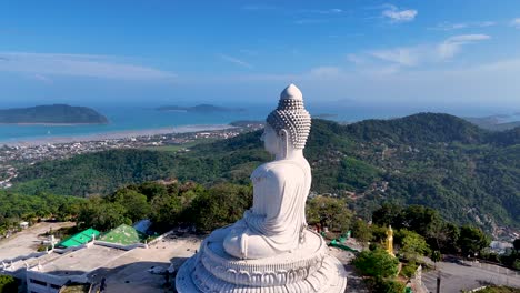 aerial view of the big buddha statue in phuket, thailand, with panoramic views of lush hills and the ocean